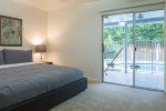 Master bedroom w/ king size bed and private backyard access